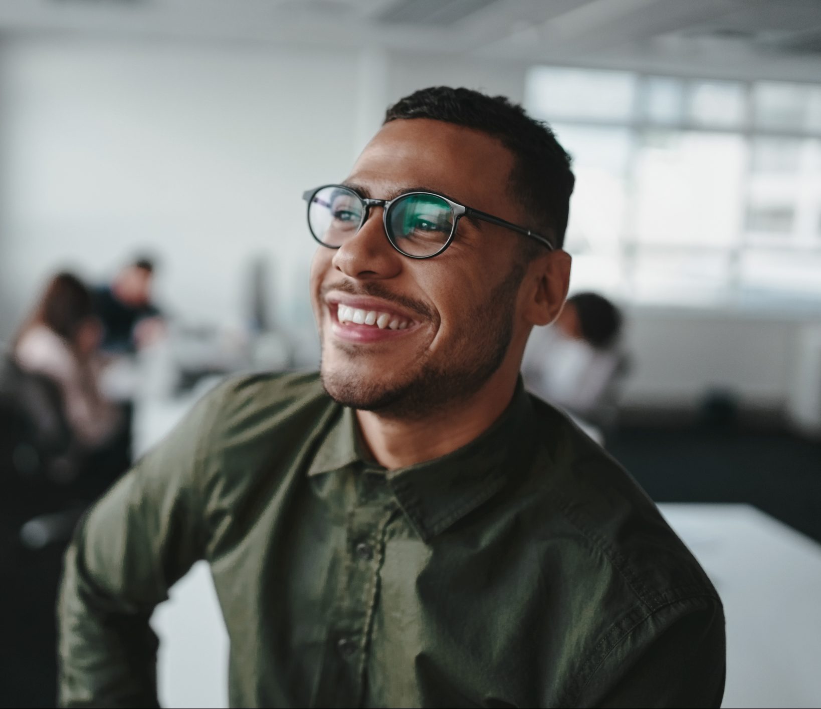 A smiling businessman wearing professional glasses.