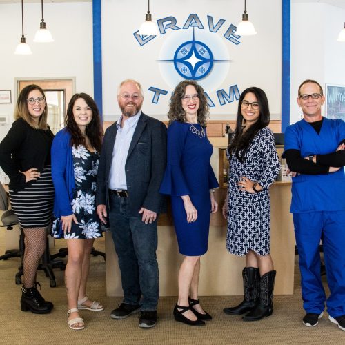 The Brave Optical team poses in their office space.